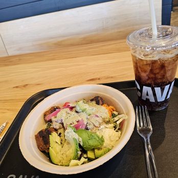 CAVA - My tray with my Lamb & Avocado bowl and fountain soda on the table where I was seated. - Mediterranean Near Me - Roanoke, Virginia