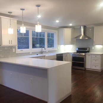 Ready to Sell Renovations - a kitchen with white cabinets and wood floors - General Contractors Near Me - Edgewater, Maryland Ready to Sell Renovations - a kitchen with white cabinets and wood floors - General Contractors Near Me - Edgewater, Maryland