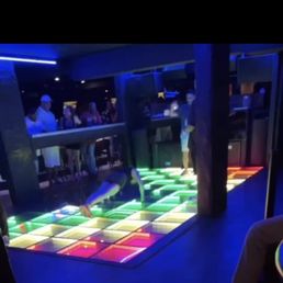 Playbar - a woman doing pushups on the dance floor - interior - Dance Clubs Near Me - Honolulu, Hawaii