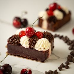 Sweet Castle Bakery - Rich and fluffy gluten-free Forest Cake, layered to perfection with a touch of indulgence.