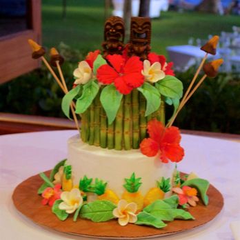 Ghiselani Designer Wedding Cakes - a cake decorated with flowers and tiki - Bakeries Near Me - Makawao, Hawaii Ghiselani Designer Wedding Cakes - a cake decorated with flowers and tiki - Bakeries Near Me - Makawao, Hawaii