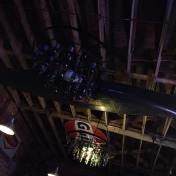 Hey Joe's - These chandeliers are rigged up in used beer bottles . It looks cool - American Near Me - Cleveland, Mississippi
