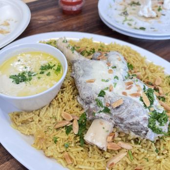 Iraklis - Another angle of Mansaf with spicy sauce that is in the background - Syrian Near Me - Santa Clara, California Iraklis - Another angle of Mansaf with spicy sauce that is in the background - Syrian Near Me - Santa Clara, California