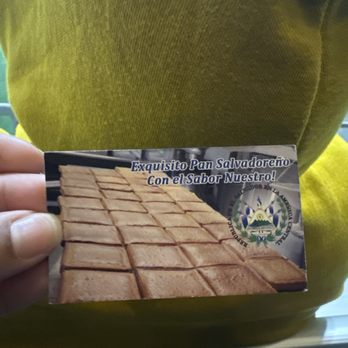 Panaderia Salvadorena - a person holding a business card - Bakeries Near Me - Hempstead, New York