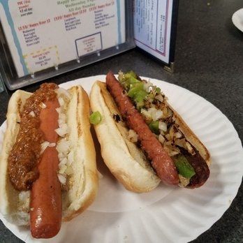 Perfectly Frank - Thick Skinned hot dog with spicy mustard, onions, chili. (Left)  New York hot sausage with spicy mustard, peppers, onions. (Right) - New American Near Me - Chesapeake, Virginia