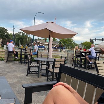 Beartown Bar & Grill - a woman sitting on a bench with a drink in her hand - Lounges Near Me - St Paul, Minnesota