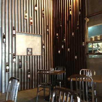 La Bonne Table - Pretty wall with wine bottle decorations - French Near Me - Adelaide, SA