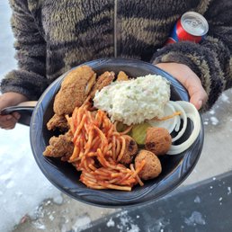 a person holding a plate of food a person holding a plate of food