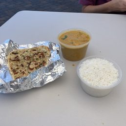 Butter chicken, garlic naan, and rice