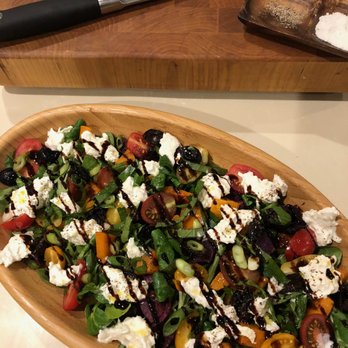 April Crowley, RD - A dish we made at a recent gathering. Mache topped with roasted and fresh veggies, burrata, torn basil, and balsamic glaze. Yum! - Dietitians Near Me