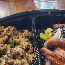 Two meat plate with brisket and beef sausage and green beans and dirty rice. Two meat plate with brisket and beef sausage and green beans and dirty rice.