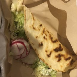 a tortilla with lettuce and radishes a tortilla with lettuce and radishes