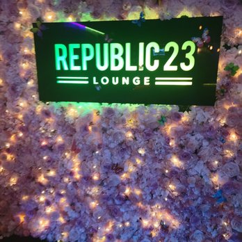 Republic 23 - a sign in front of a bed of flowers - Lounges Near Me - Bergenfield, New Jersey