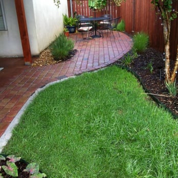Lafayette Landscape - a view of a backyard with a brick walkway - Landscaping Near Me - Lafayette, Louisiana