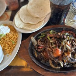 El Paso Mexican Grill - Steak fajitas with red & green bell peppers, onions, tortillas, beans, rice, guacamole, pico de gallo, sour cream, and queso, chips, & Coke.