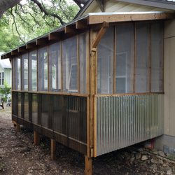 Krohmer Enterprises - We used galvanized metal for the sides and transparent panels for the front. The roof brackets match those on the house.