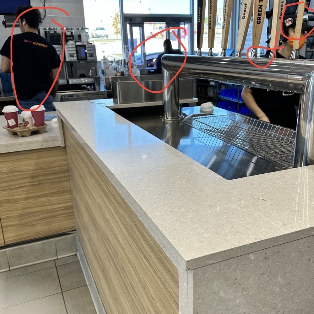 Dunkin' -  a man working at a counter in a store - Donuts Near Me - Harker Heights, Texas