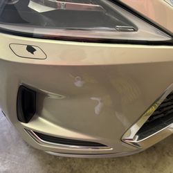 Paint removed on passenger side headlight washer cap