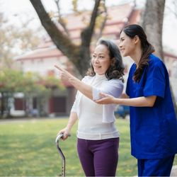 Assisting Hands Home Care - A professional caregiver from Assisting Hands Home Care supports a senior client during a safe, enjoyable walk outdoors...