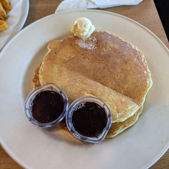 Molly Brown's Country Cafe - Short stack of pancakes (2 pancakes) with a dollop of butter and two containers of syrup - Breakfast & Brunch Near Me - Hesperia, California Molly Brown's Country Cafe - Short stack of pancakes (2 pancakes) with a dollop of butter and two containers of syrup - Breakfast & Brunch Near Me - Hesperia, California