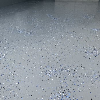 Prep'n Sell - After: The second image reveals a stunning transformation with a freshly applied epoxy coating that includes a striking blue and silver flak - General Contractors Near Me - Mississauga, Ontario Prep'n Sell - After: The second image reveals a stunning transformation with a freshly applied epoxy coating that includes a striking blue and silver flak - General Contractors Near Me - Mississauga, Ontario