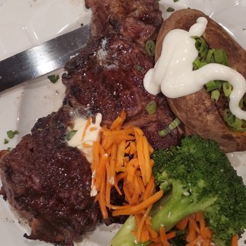 Jameson's Charhouse - Ribeye dinner with loaded baked potato and veggies - Steakhouses Near Me - Mount Prospect, Illinois
