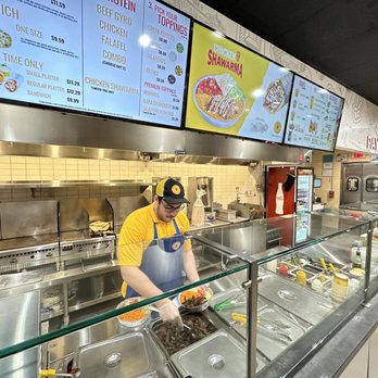 The Halal Guys - a man preparing food in a restaurant - Middle Eastern Near Me - North Bergen, New Jersey The Halal Guys - a man preparing food in a restaurant - Middle Eastern Near Me - North Bergen, New Jersey