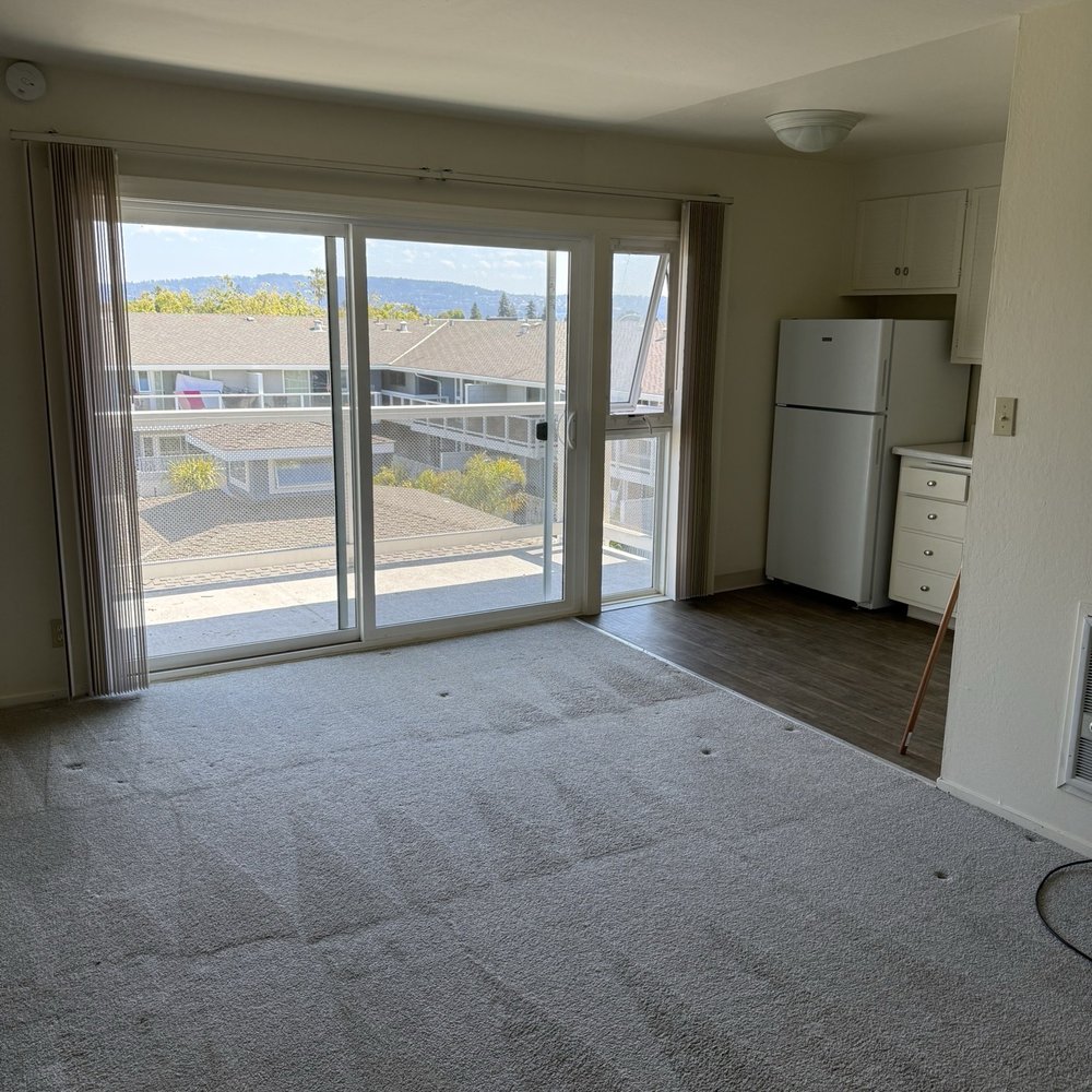 Franciscan Apartments - Living room overlooking courtyard/pool - Apartments Near Me - Alameda, California