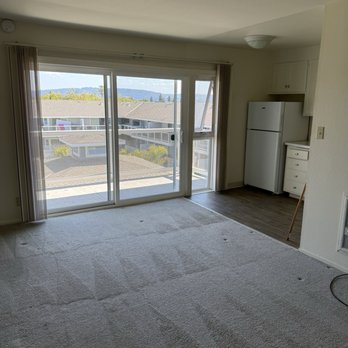 Franciscan Apartments - Living room overlooking courtyard/pool - Apartments Near Me - Alameda, California Franciscan Apartments - Living room overlooking courtyard/pool - Apartments Near Me - Alameda, California