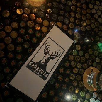 Saraveza - Cool tables - all of them have bottle caps inside - Beer, Wine & Spirits Near Me - Portland, Oregon Saraveza - Cool tables - all of them have bottle caps inside - Beer, Wine & Spirits Near Me - Portland, Oregon