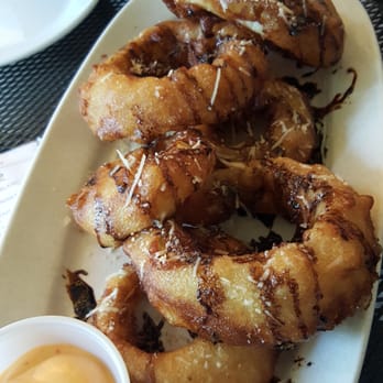 Dad's Kitchen - Deliciously crispy onion rings with a balsamic reduction and parmesan cheese!! Sooooo yummy!! - New American Near Me - Fair Oaks, California