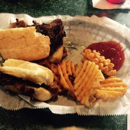 a basket of food including a sandwich, fries, and ketchup