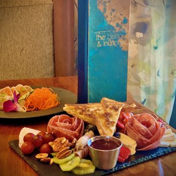 Bear Springs Hotel - Charcuterie Platter at the Bistro. Garlic Albacore appetizer in the background. - Hotels Near Me - Highland, California Bear Springs Hotel - Charcuterie Platter at the Bistro. Garlic Albacore appetizer in the background. - Hotels Near Me - Highland, California