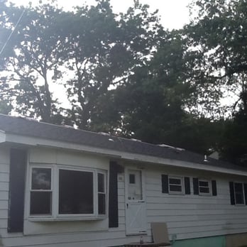Lagunes Home Remodeling - a white house with black shutters - Roofing Near Me Lagunes Home Remodeling - a white house with black shutters - Roofing Near Me