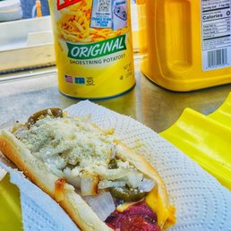 a hot dog with cheese and pickles