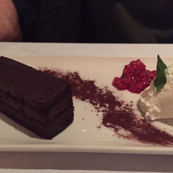 Atlantic Fish - The chocolate marquis: a flourless chocolate cake with raspberries, cocoa powder, and fresh whipped cream. - Seafood Near Me - Boston, Massachusetts Atlantic Fish - The chocolate marquis: a flourless chocolate cake with raspberries, cocoa powder, and fresh whipped cream. - Seafood Near Me - Boston, Massachusetts