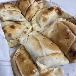 Pastelería Doña Cata - Empanada de pink with meat, onions, hard boiled egg and an olive