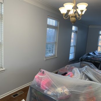 J Parral Contractor - a living room with a chandelier - General Contractors Near Me