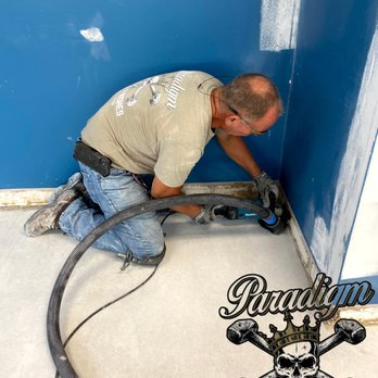 Paradigm Concrete Finishes - a man working on a wall - Flooring Near Me - Sarasota, Florida