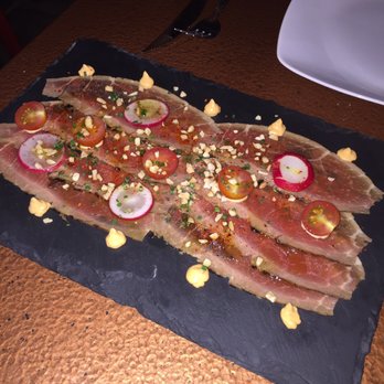 Cera 23 - Carpaccio de presa iberica. Iberian pork fillet carpaciio w tomato, almonds, and kimchi mayo 9,50 - Spanish Near Me - Barcelona, B