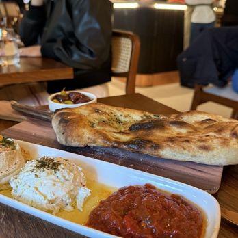 Frena - Dip trio (hummus, tzatziki, and matbucha) and frena bread which - Mediterranean Near Me - New York, New York Frena - Dip trio (hummus, tzatziki, and matbucha) and frena bread which - Mediterranean Near Me - New York, New York