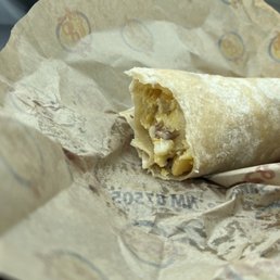 a burrito wrapped in brown paper