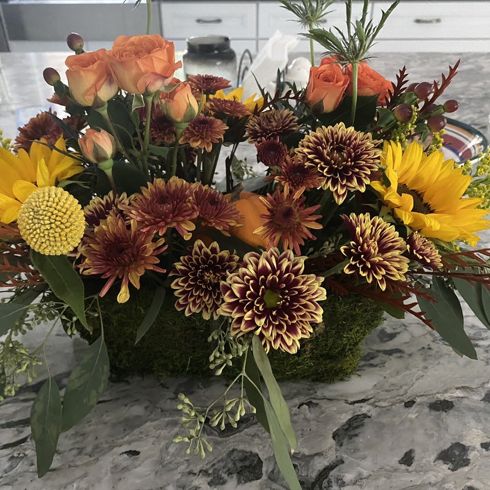 Moss container with fall floral bouquet and small pumpkin. Moss container with fall floral bouquet and small pumpkin.
