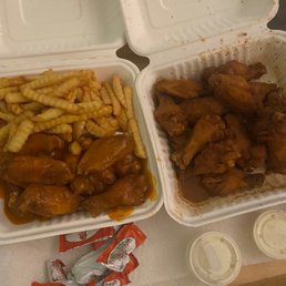 a tray of chicken wings and french fries