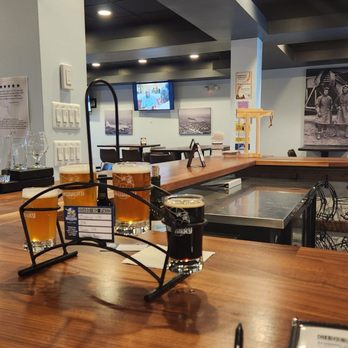 Blue Skies Brewery - a wooden bar with two beer glasses on it - Breweries Near Me - Auburn Hills, Michigan Blue Skies Brewery - a wooden bar with two beer glasses on it - Breweries Near Me - Auburn Hills, Michigan