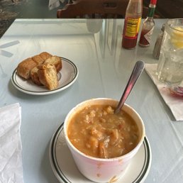 a bowl of soup and a plate of croissants