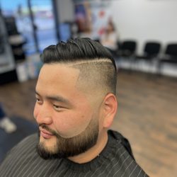 True Gents Barbershop - Low skin fade with a part combover and a beard line up