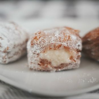 Parlor Doughnuts - Coconut Cream Filled (Mini). A petite treat with a satisfying crunch, revealing a cool, creamy coconut filling. - Donuts Near Me - Laguna Niguel, California