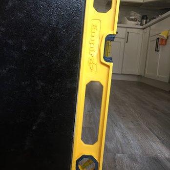 Tez Marble - see how the granite edge isn't straight compared to the straight edge of the yellow hardware? - Building Supplies Near Me - Burlingame, California Tez Marble - see how the granite edge isn't straight compared to the straight edge of the yellow hardware? - Building Supplies Near Me - Burlingame, California