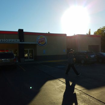 Burger King - a man walking across a parking lot - Burgers Near Me - Boise, Idaho